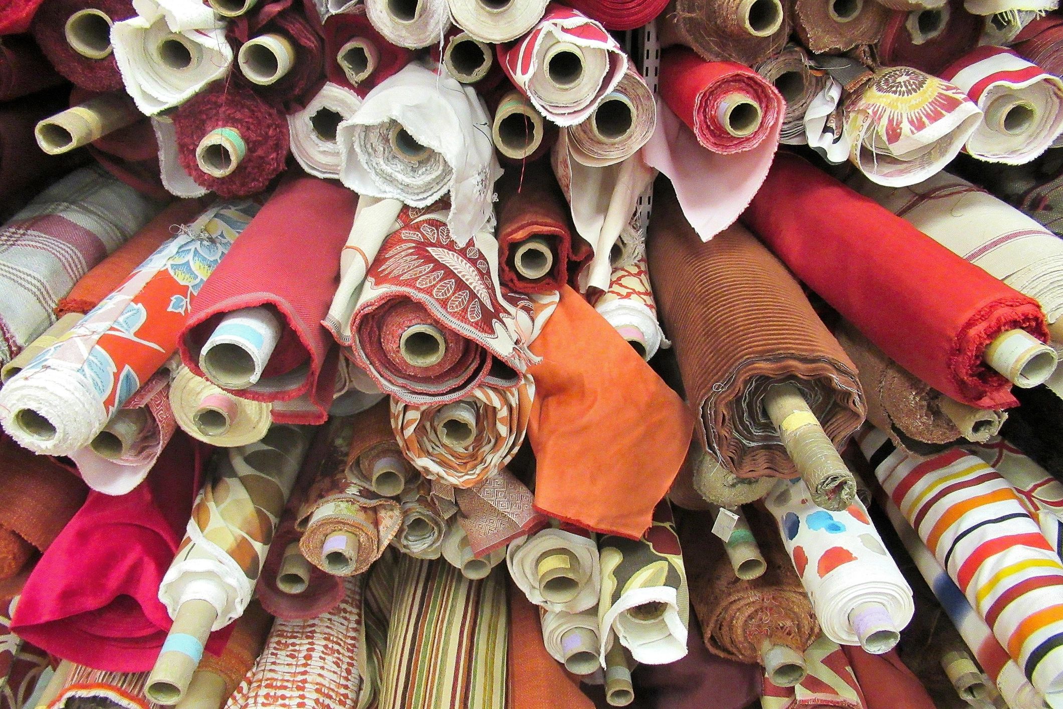 Bolts of colored fabric arranged in an elegant display