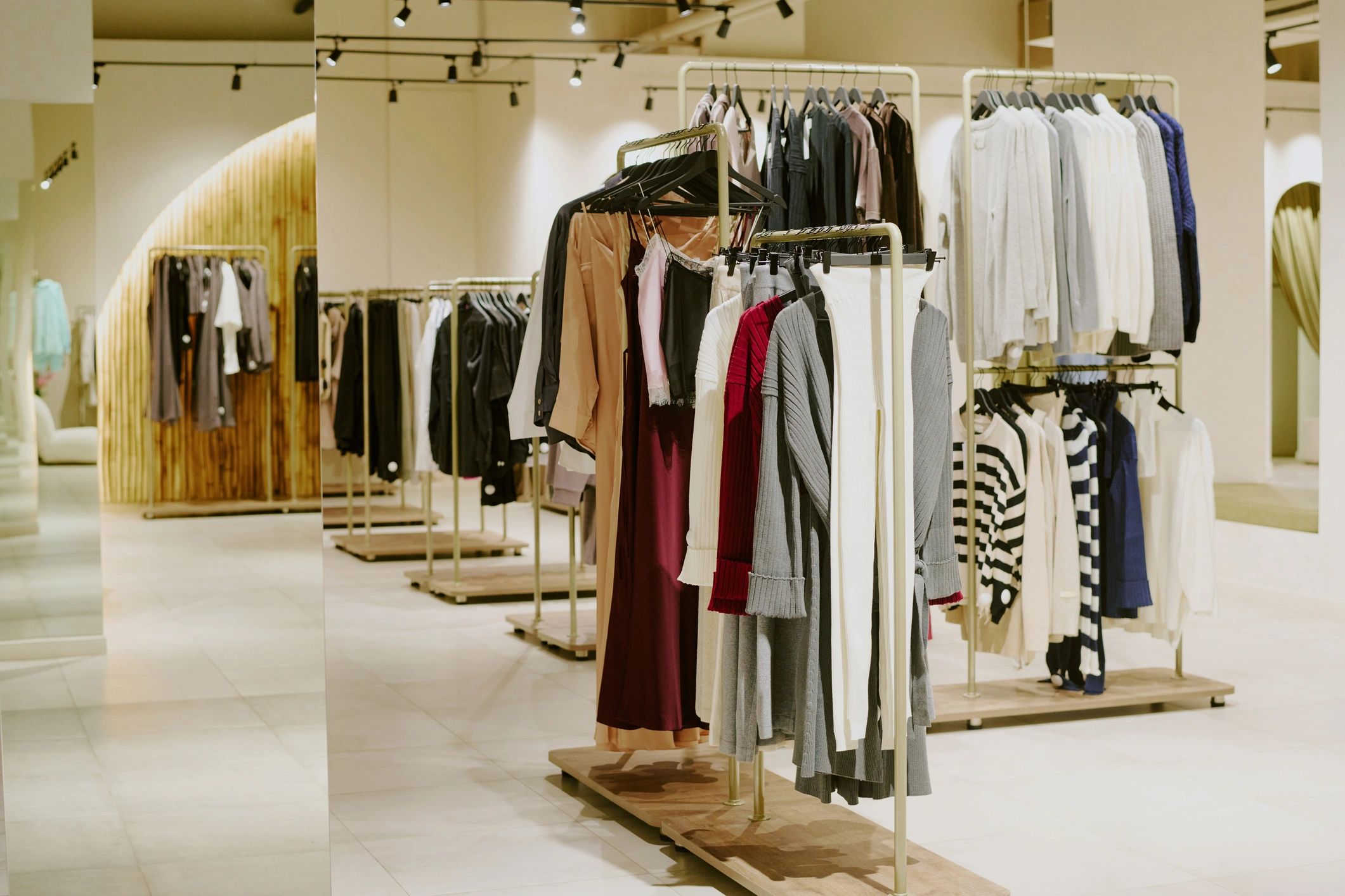 Designer female clothes on hangers in a boutique collection display