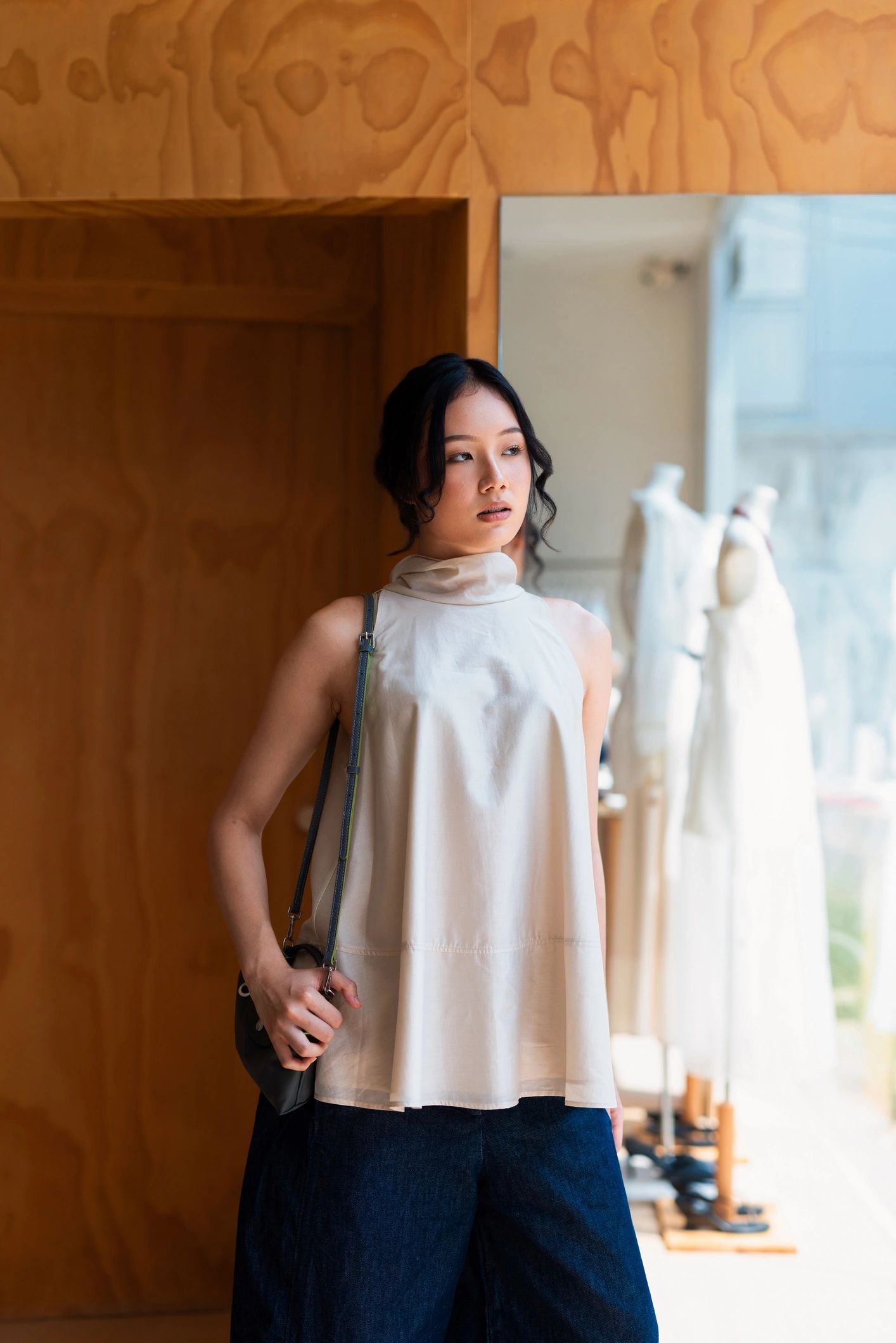 Young woman shopping in a minimalist fashion boutique